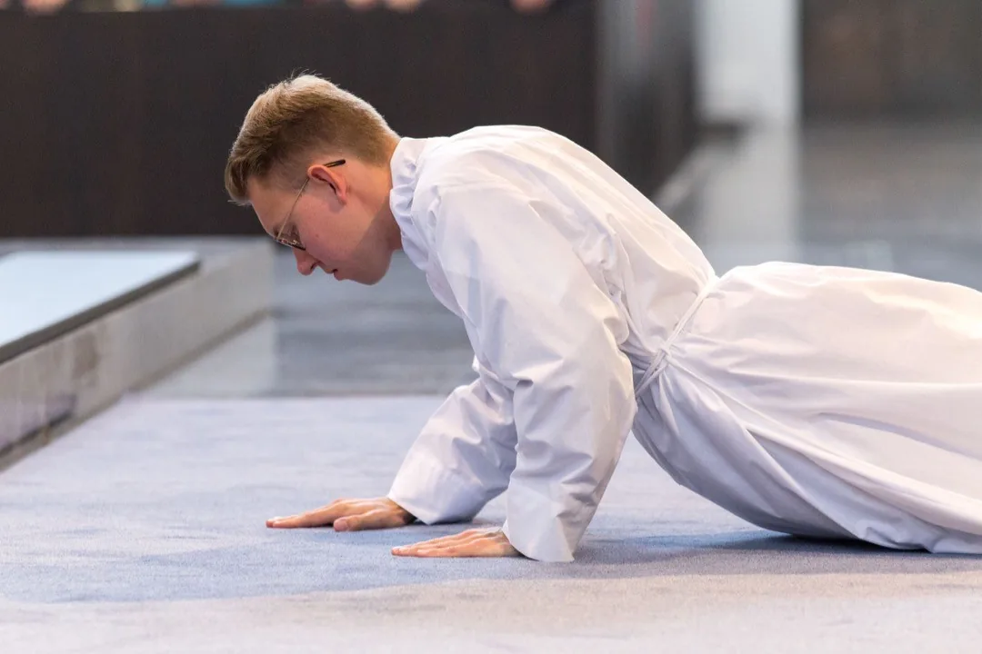 Deacon lying face down during an ordination ceremony by Andreas Düren